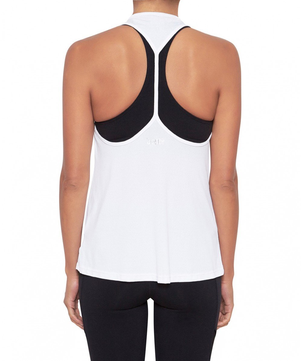 Front view product image with model for Brasilfit activewear W workout tank in white.  The W workout tank is part of our activewear collection that is focused on performance, high compression activewear.